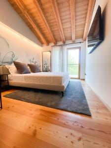 a bedroom with a bed and a large window at Agriturismo Camerin - CL Agri Lounge in Conegliano