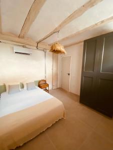 a bedroom with a large bed and a door at Casa Purissima in Ontinyent +6 photos