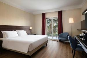 a hotel room with a bed and a window at Courtyard by Marriott Rome Central Park in Rome +58 photos