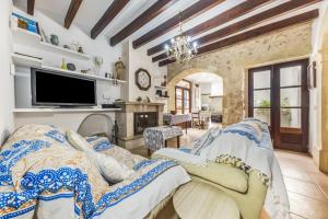 a living room with a bed and a tv at Can Vallori in Sencelles