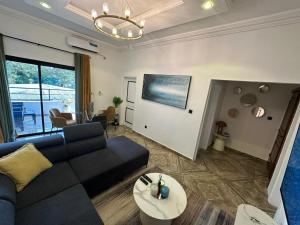 a living room with a couch and a table at Bonapriso in Douala