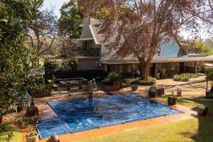 a large swimming pool in front of a house at Adem Gasteplaas & Function Venue in Kroondal