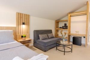 a bedroom with a bed and a couch and a table at Andelice Zante in Argassi +58 photos