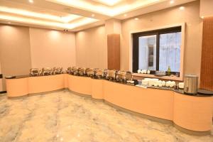 a lobby with a waiting room with a row of chairs at Hotel Radian INN in Gorakhpur