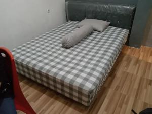 a bed with a pillow on top of it at Kost Eka Gorontalo in Telaga