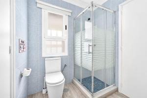 a bathroom with a toilet and a glass shower at CHALET 273 con PISCINA PRIVADA in Callao Salvaje +11 photos