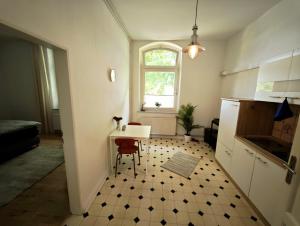 a small kitchen with a table and a window at Tolle Moderne Altbau Wohnung in Hohenlockstedt