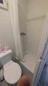 a white bathroom with a toilet and a shower at Appartement proche gare in Nice