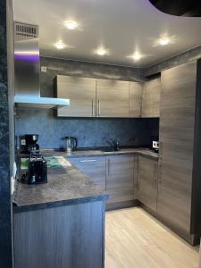 a kitchen with wooden cabinets and a counter top at Ferienwohnung Liliana in Dannenfels