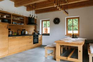 a kitchen with wooden cabinets and a wooden table at Výtoň 263 in Přední Výtoň