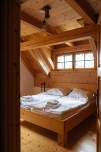a bedroom with a bed in a wooden room at Výtoň 263 in Přední Výtoň
