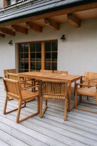 a wooden picnic table and benches on a deck at Výtoň 263 in Přední Výtoň +24 photos
