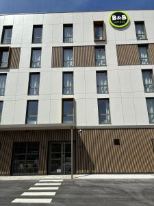 an external view of the front of a building at B&B HOTEL Amiens Sud in Amiens