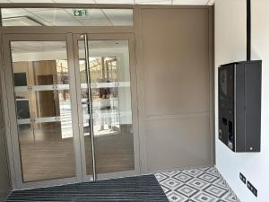 a room with sliding glass doors and a television at B&B HOTEL Amiens Sud in Amiens +18 photos