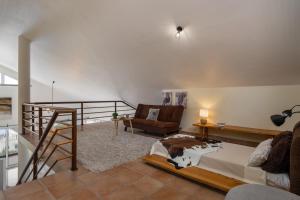 a bedroom with a bed and a chair at Villa Sea Colors by An Island Apart in Arco da Calheta +37 photos