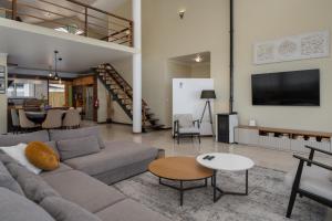 a living room with a couch and a table at Villa Sea Colors by An Island Apart in Arco da Calheta