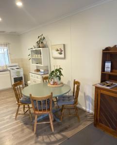 a kitchen with a table and chairs in a room at Barossa Suites on Basedow in Tanunda