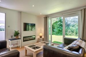 a living room with a couch and a fireplace at Finest Retreats - Brockwood in Bradworthy