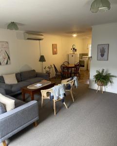 a living room with a couch and a table at Barossa Suites on Basedow in Tanunda