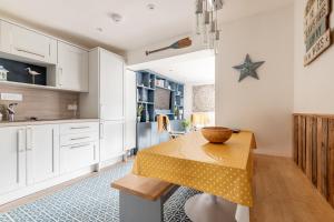 a kitchen with a table with a bowl on it at Driftwood - Crail in Crail
