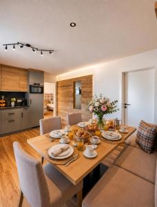 a dining room with a wooden table and chairs at Bergdiamant Nauders in Nauders +52 photos