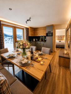 a dining room with a table with flowers on it at Bergdiamant Nauders in Nauders