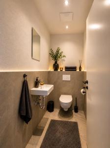 a bathroom with a toilet and a sink at Bergdiamant Nauders in Nauders