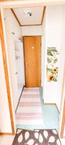 a hallway with a wooden door and a carpet at Lakeuden Sydän in Kauhajoki