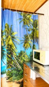 a computer desk with a window with palm trees at Lakeuden Sydän in Kauhajoki