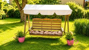 a bench in a yard with two potted plants at Lakeuden Sydän in Kauhajoki