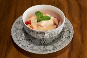 a bowl of food on a plate on a table at Mora Royal Villa in Senggigi 