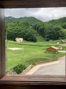 a window with a view of a field and a road at Studio Cosy pied des pistes in Saint-Léger-les-Mélèzes