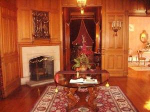 a living room with a coffee table and a fireplace at Alexander Mansion Bed and Breakfast in Winona