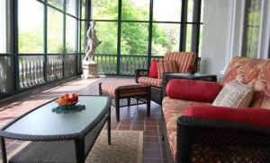 a living room with a couch and a table at Alexander Mansion Bed and Breakfast in Winona +52 photos