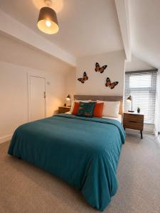 a bedroom with a large bed with a blue blanket at New Top Floor Large 1- Bed Flat in Morecambe