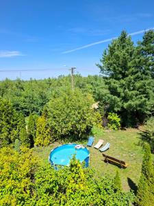 an overhead view of a yard with a swimming pool and two chairs at Kaszubska Enklawa in Rytel