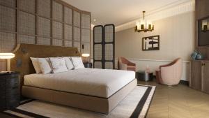 a bedroom with a bed and chairs in a room at BLESS Barcelona - New Opening 2026 in Barcelona