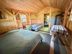 a bedroom with two beds in a wooden cabin at Lookout Cabin in Barton