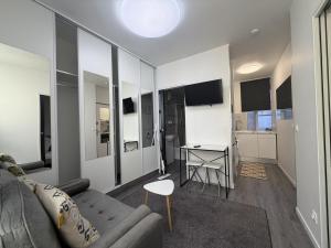 a living room with a couch and a table at La suite Saint Régis 2 in Le Puy-en-Velay +2 photos