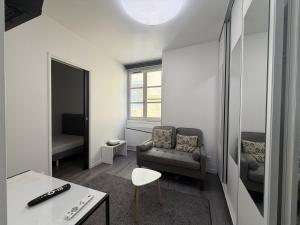 a living room with a couch and a chair at La suite Saint Régis 2 in Le Puy-en-Velay