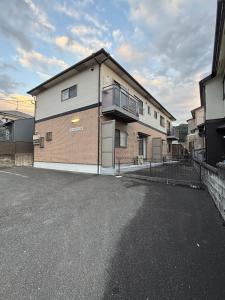 an empty parking lot in front of a building at Flat Dazaifu in Dazaifu
