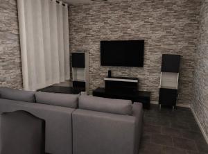 a living room with a couch and a flat screen tv at WÖRGÖTTER Sandrine in Monthermé