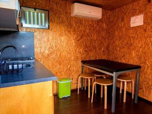 a kitchen with a table and stools in a room at Valley Cabril Selvagem in Cabril +24 photos