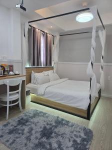 a bedroom with a canopy bed with a desk and a desk at 1001 Stars Hotel in Ho Chi Minh City +97 photos