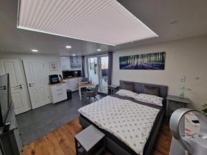 a bedroom with a bed and a kitchen with a table at Apartment am Rathaus in Heimbach