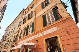 a building with an umbrella in front of it at Aura Suites in Albenga