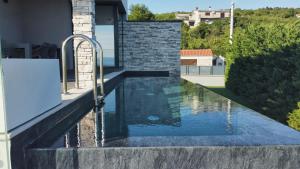 a swimming pool in the middle of a house at Villa Nina in Šmrika