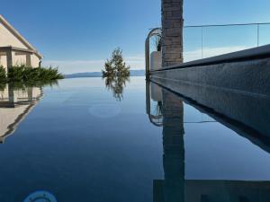a reflection of a building in the water at Villa Nina in Šmrika