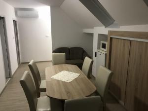 a dining room with a wooden table and chairs at Nice Big House in Balatonfenyves