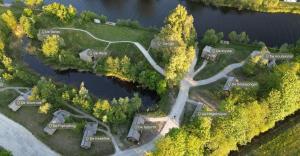 an aerial view of a park next to a lake at Tiny House De Kwekfink in Westergeest +7 photos